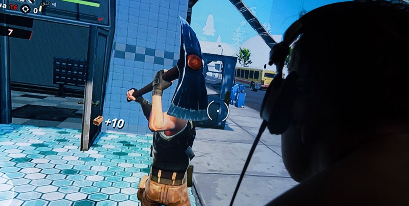 Child playing violent video game.