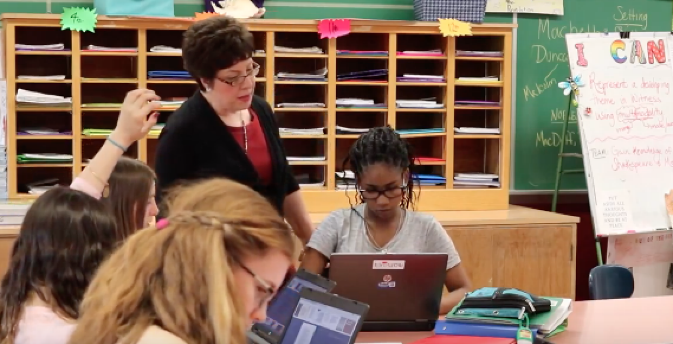 Denise Grandits, PhD student, works with her students in class on computers. 