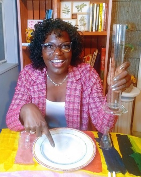 Zoom image: PhD student Raven Baxter conducting an experiment at the dinner table