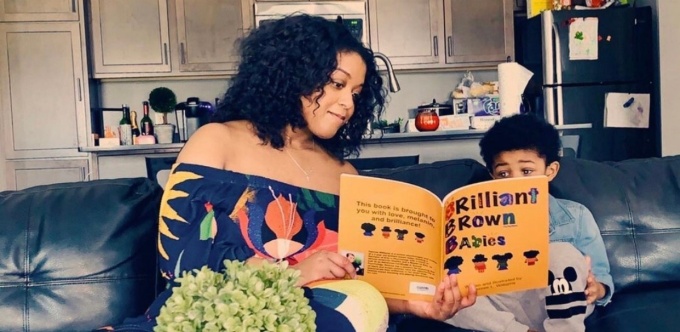 Desiree Williams reads Brilliant Brown Babies to her son. 