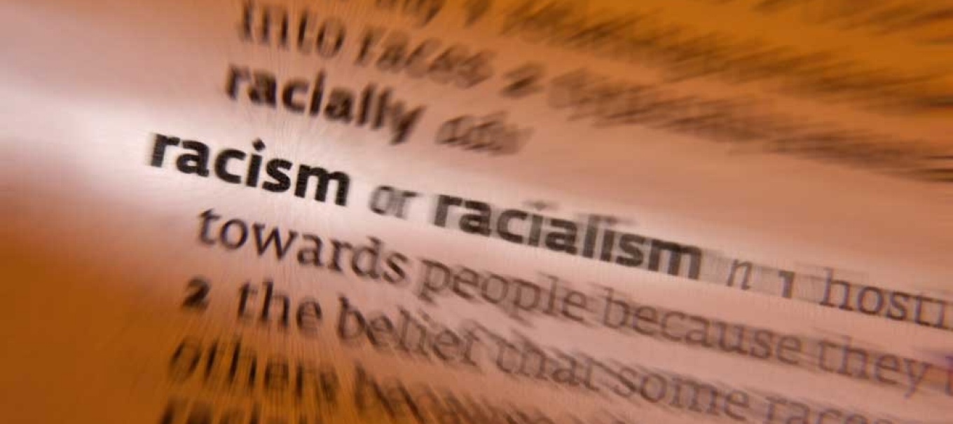 Image of the word and definition for racism in a dictionary. 