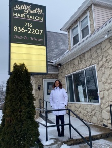 Charice Thompson standing outside her hair salon. 