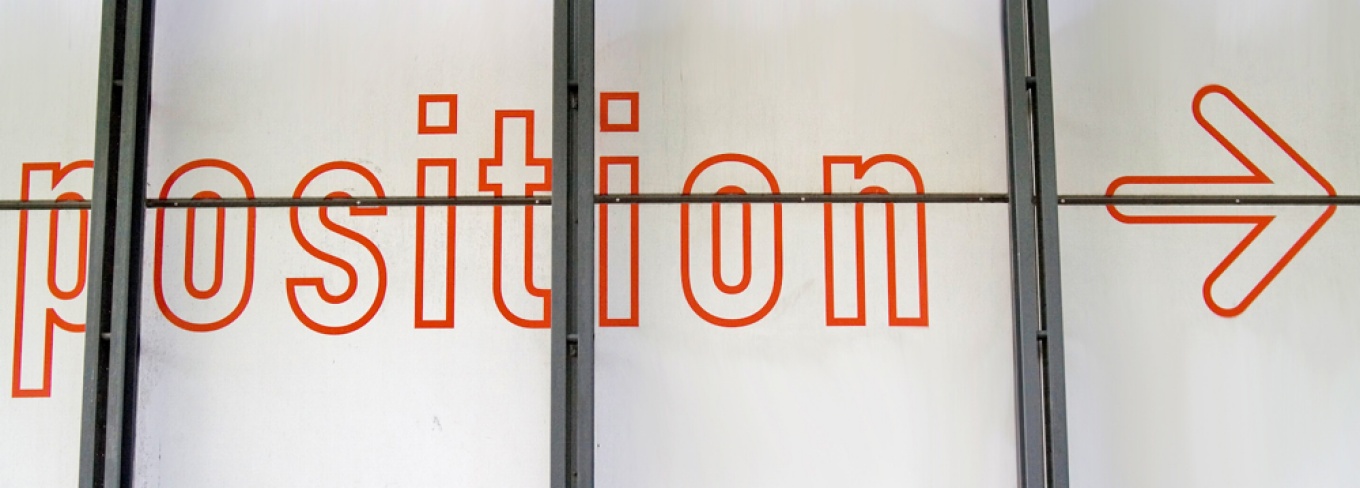 Image of artwork on a wall spelling out the word "position." Photo by Rui Pereira. 