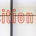 Image of artwork on a wall spelling out the word "position.". 