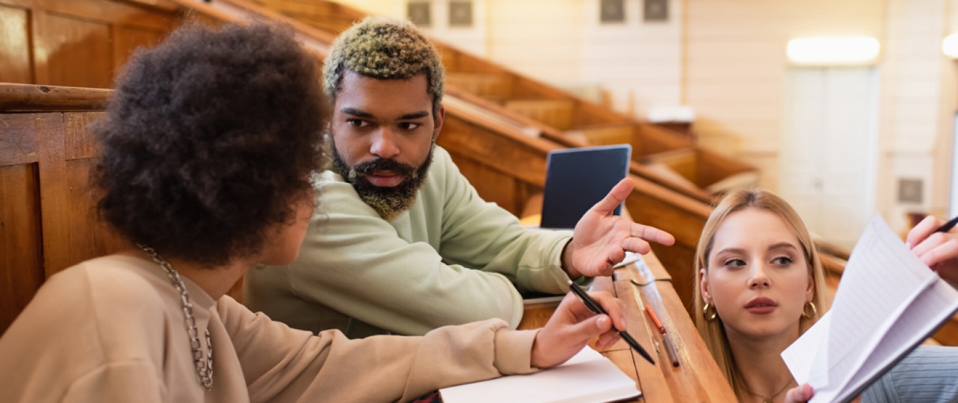 Students in a college classroom in discussion. 
