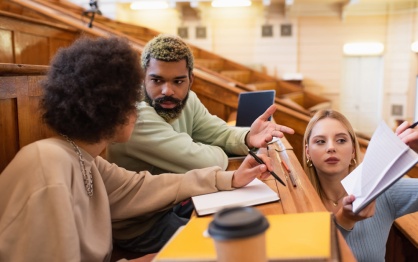 Students in a college classroom in discussion. 