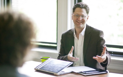 Image of Chris Hoadley in discussion with a colleague. 