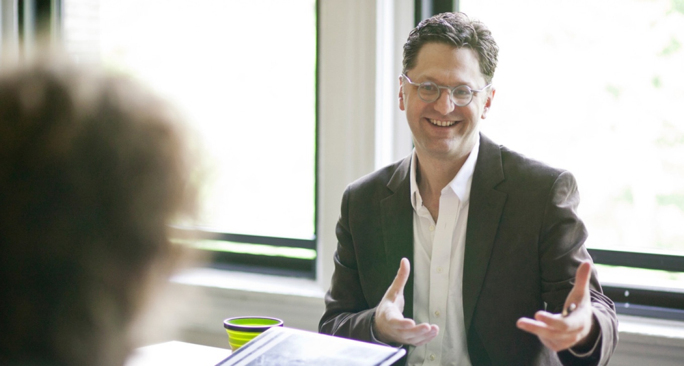 Image of Chris Hoadley in discussion with a colleague. 