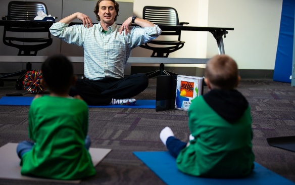 Zoom image: Vito Gigante, director of occupational therapy at the Beyond Learning Center (formerly the Cantalician Center for Learning), leads young children in a yoga practice.