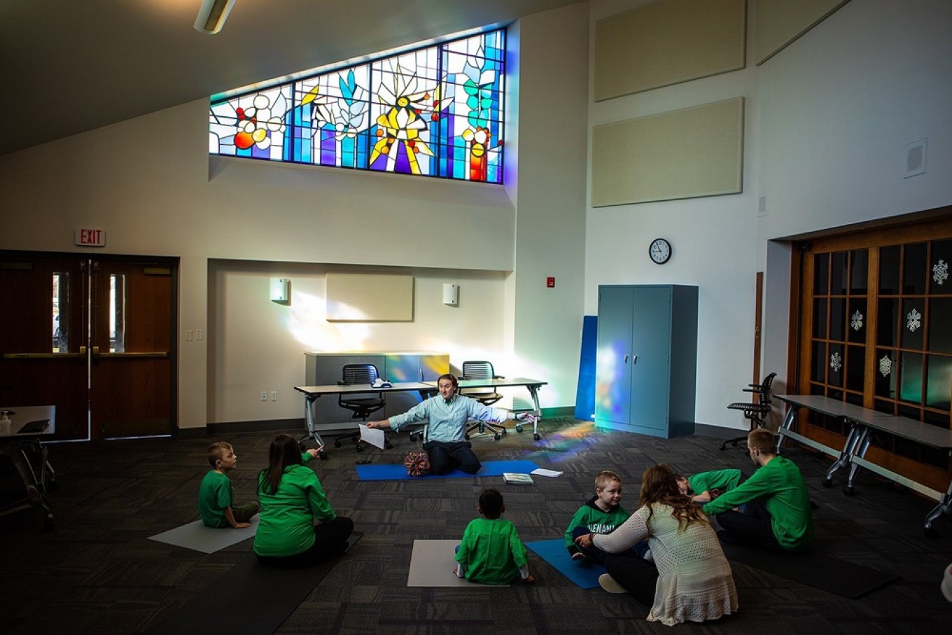 Vito Gigante, director of occupational therapy at the Beyond Learning Center (formerly the Cantalician Center for Learning), leads young children in a yoga practice. Photos: Douglas Levere. 