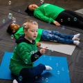 A young child practicing yoga on a mat. 