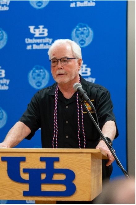 Zoom image: McAfee speaking at the 2022 UB Veterans Cord Ceremony, which recognizes veteran student graduates in a special pre-commencement event. 