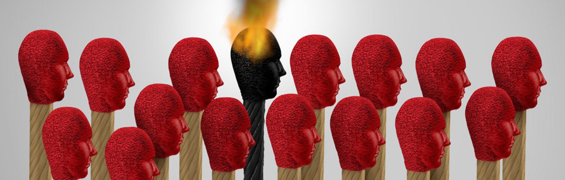 Conceptual image of matches in the shape of human heads, one lit and burning out signifying the idea of "burnout.". 