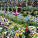 Image of flowers and peace doves set on the ground in honor of those who lost their lives at the May 14, 2023 Tops shooting in Buffalo, NY. 