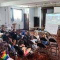 Students in auditorium in Buffalo, NY, watching presentation about the roots of rap. 