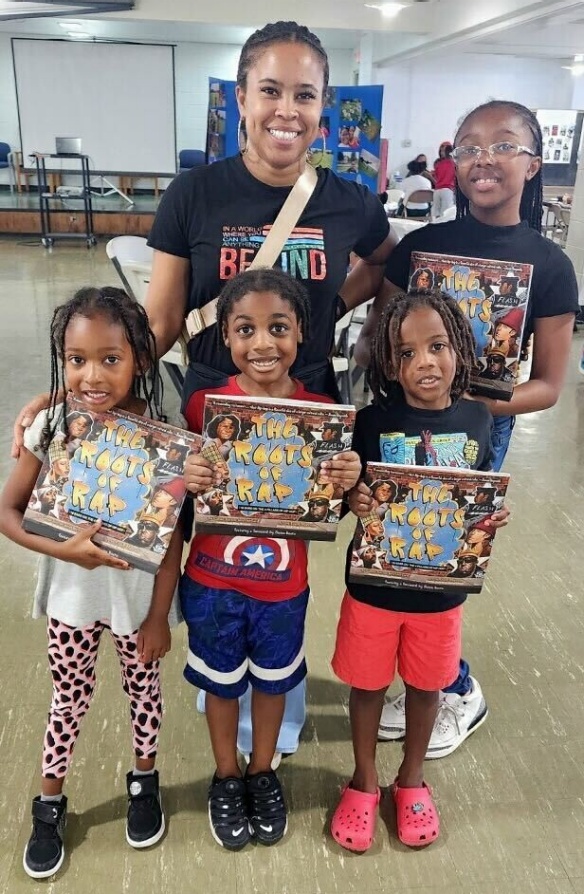 Zoom image: Students received &quot;The Roots of Rap&quot; book as part of the event. 