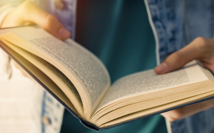 Young man holding a book. 