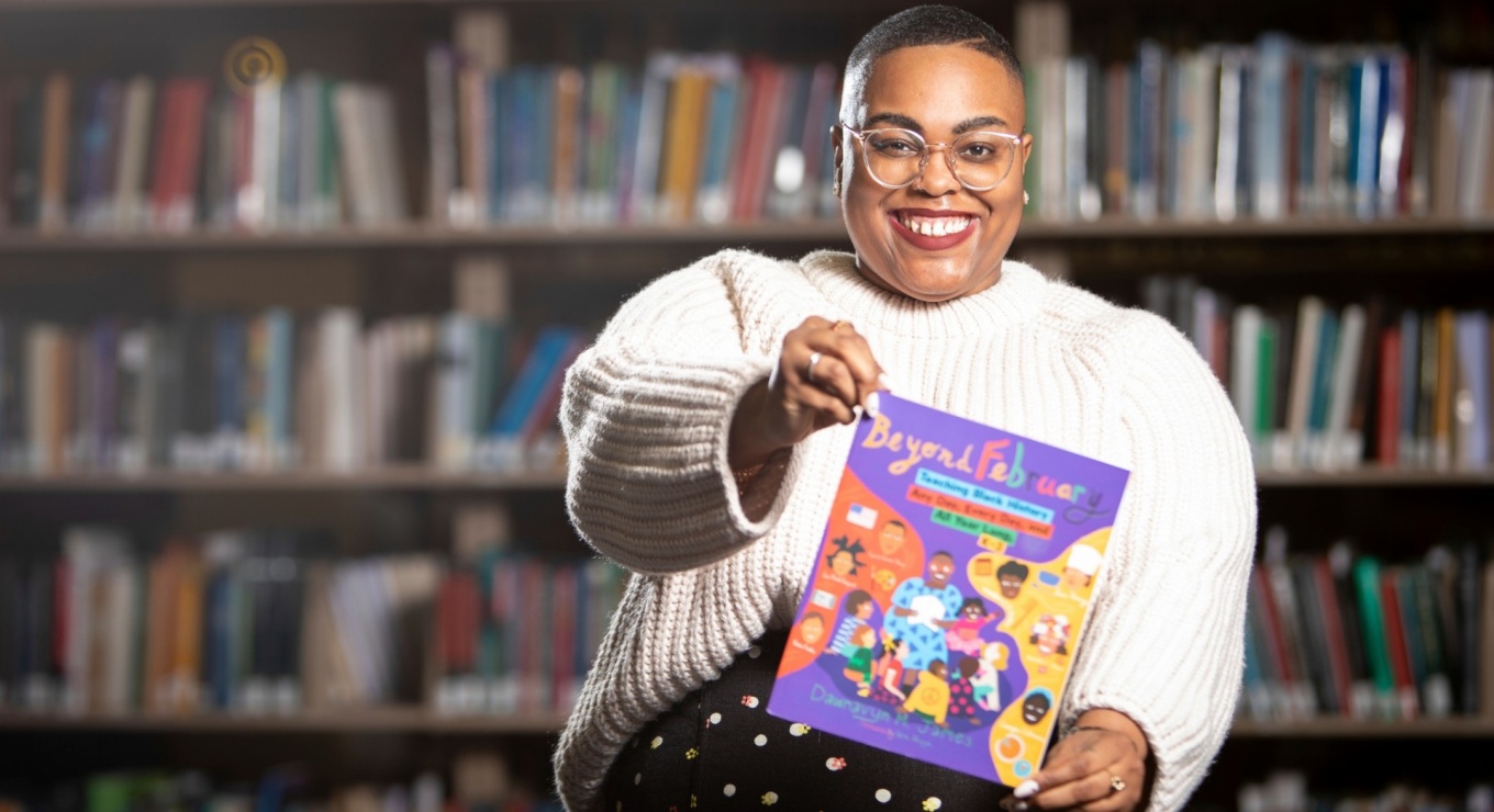 Dawnavyn James holding her book "Beyond February.". 