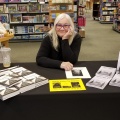 Kelly Devine, MS ’22 with her book at a signing table. 