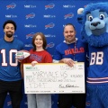 Breanna Pelonero and representatives from M&T, Billy Buffalo Mascot, Khalil Shakir, and Maryvale's pricipal pose with a large check. 