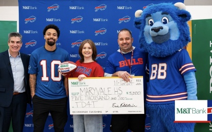 Breanna Pelonero and representatives from M&T, Billy Buffalo Mascot, Khalil Shakir, and Maryvale's pricipal pose with a large check. 