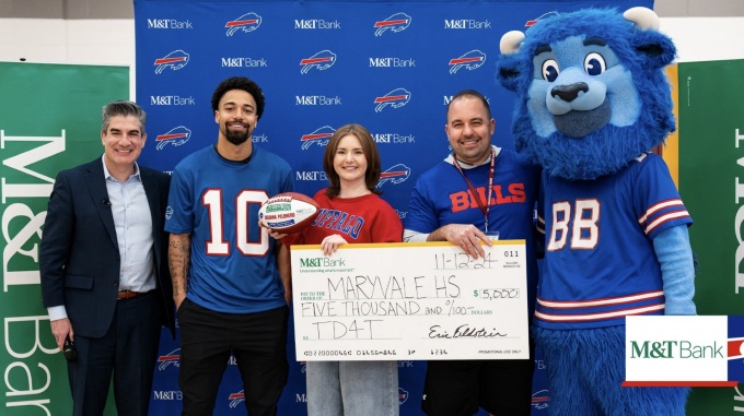 Breanna Pelonero accepting giant check.