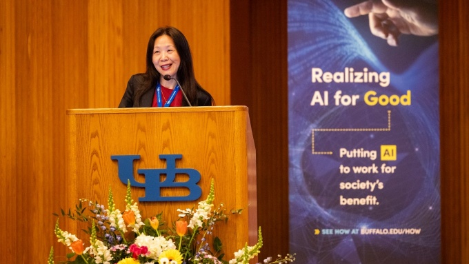 Christine Wang speaking at AI related lecture. 