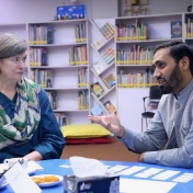 Amy VanScoy discusses the research with a librarian from Chughtai Public Library. 