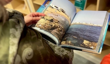 VanScoy looks through the book “Pakistan Maritime Tourism.”.