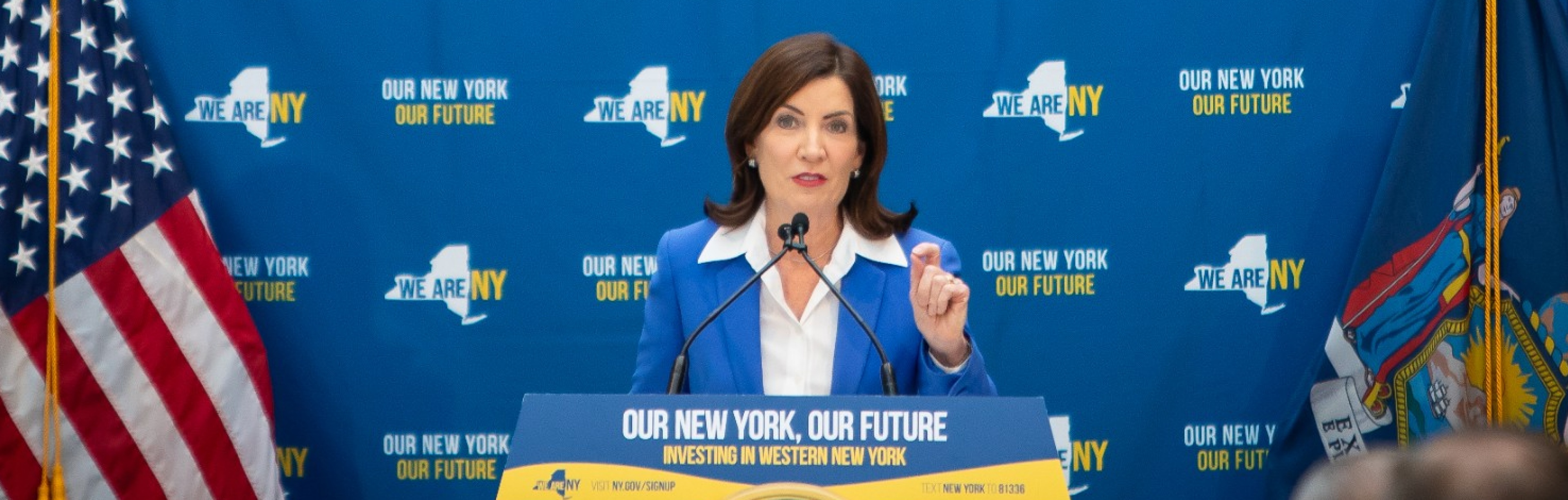 NY Governor Kathy Hochul talking at a podium. 
