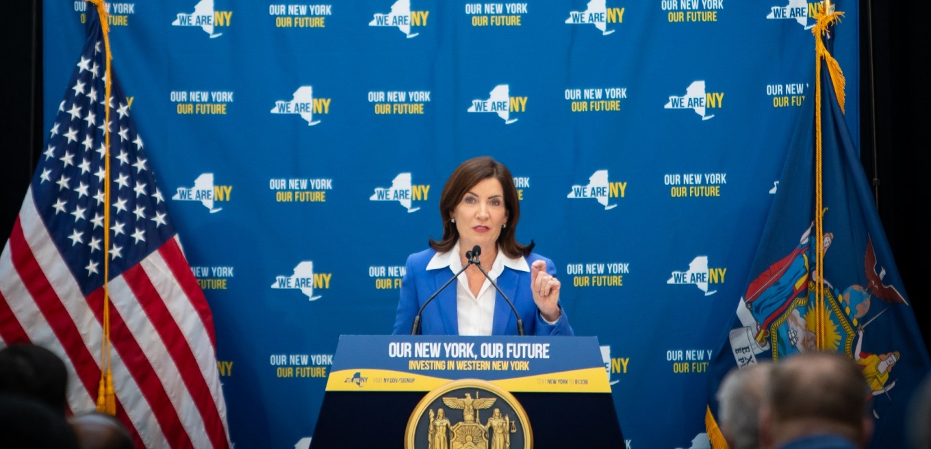 Kathy Hochul stading at a podium. 