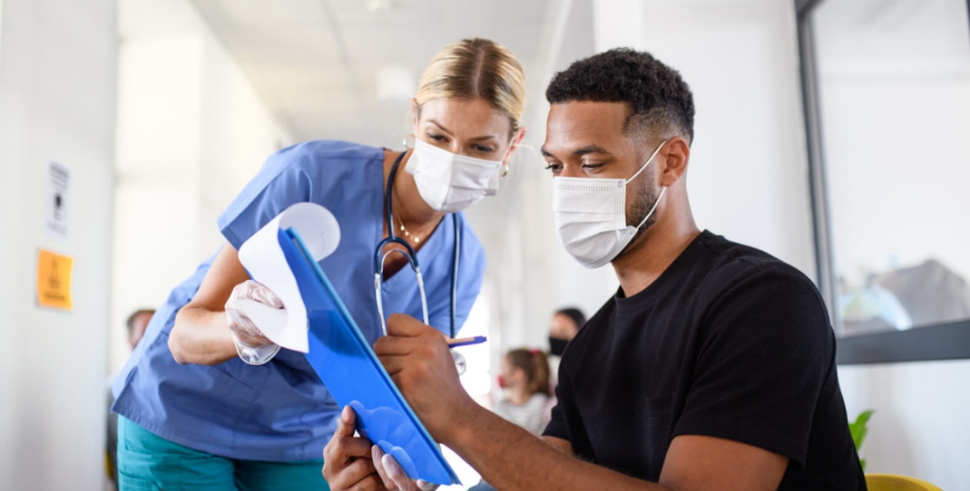 Nurse assisting a male African American patient. 