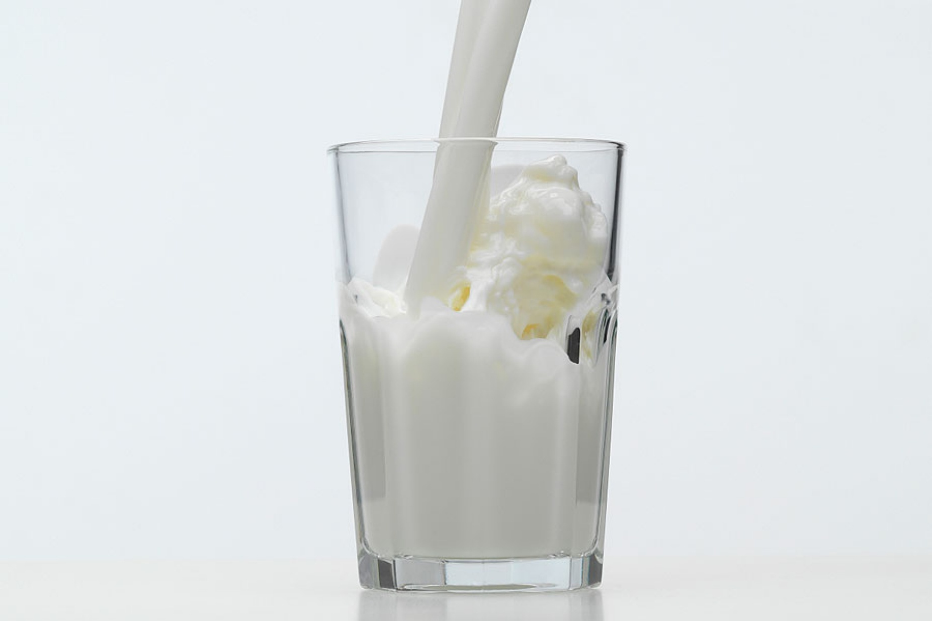 Milk being poured into a glass.