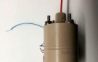 A cylindrical object with several wires protruding from it. 