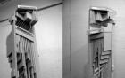 In black-and-white, a bird house-like contraption with many angular parts. 