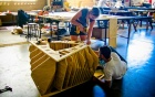 Students working on a structure with many plywood panels. 