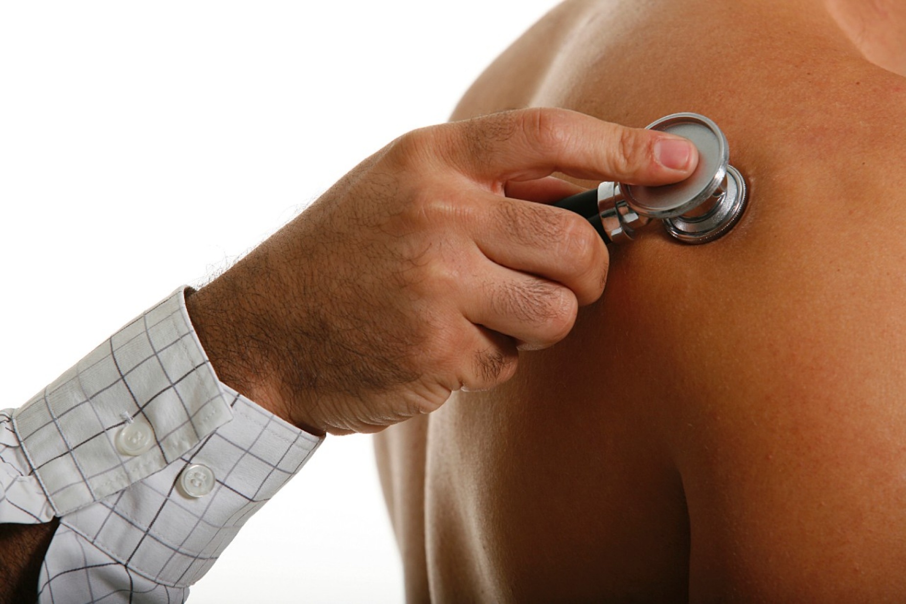 Close up view of a doctor using a stethoscope to examine a patient.