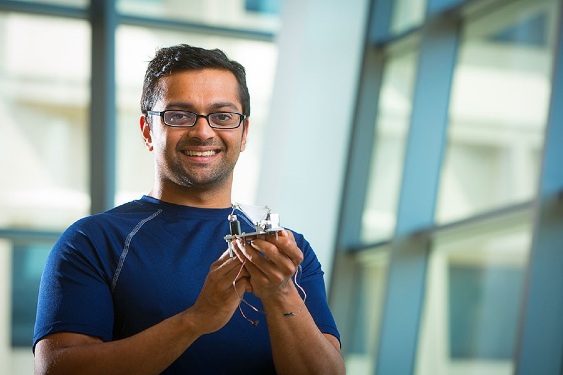 Manoranjan Majji, holding the Canfield joint actuation manipulator, a tennis-ball sized device that can automatically control a satellite. 