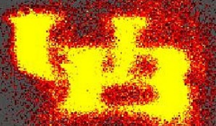 Tiny nanoballoons "fire" in a scientific image, lighting up the image in the shape of a UB logo. 