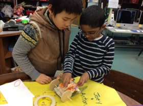 Zoom image: Anton and Ari reinforce the axle of their car. 