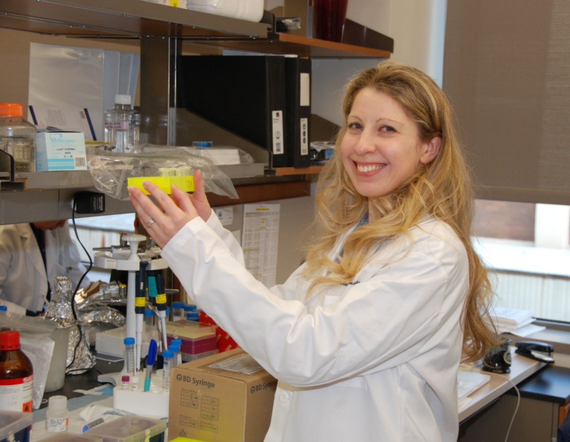 Jill Kramer holding lab sample. 