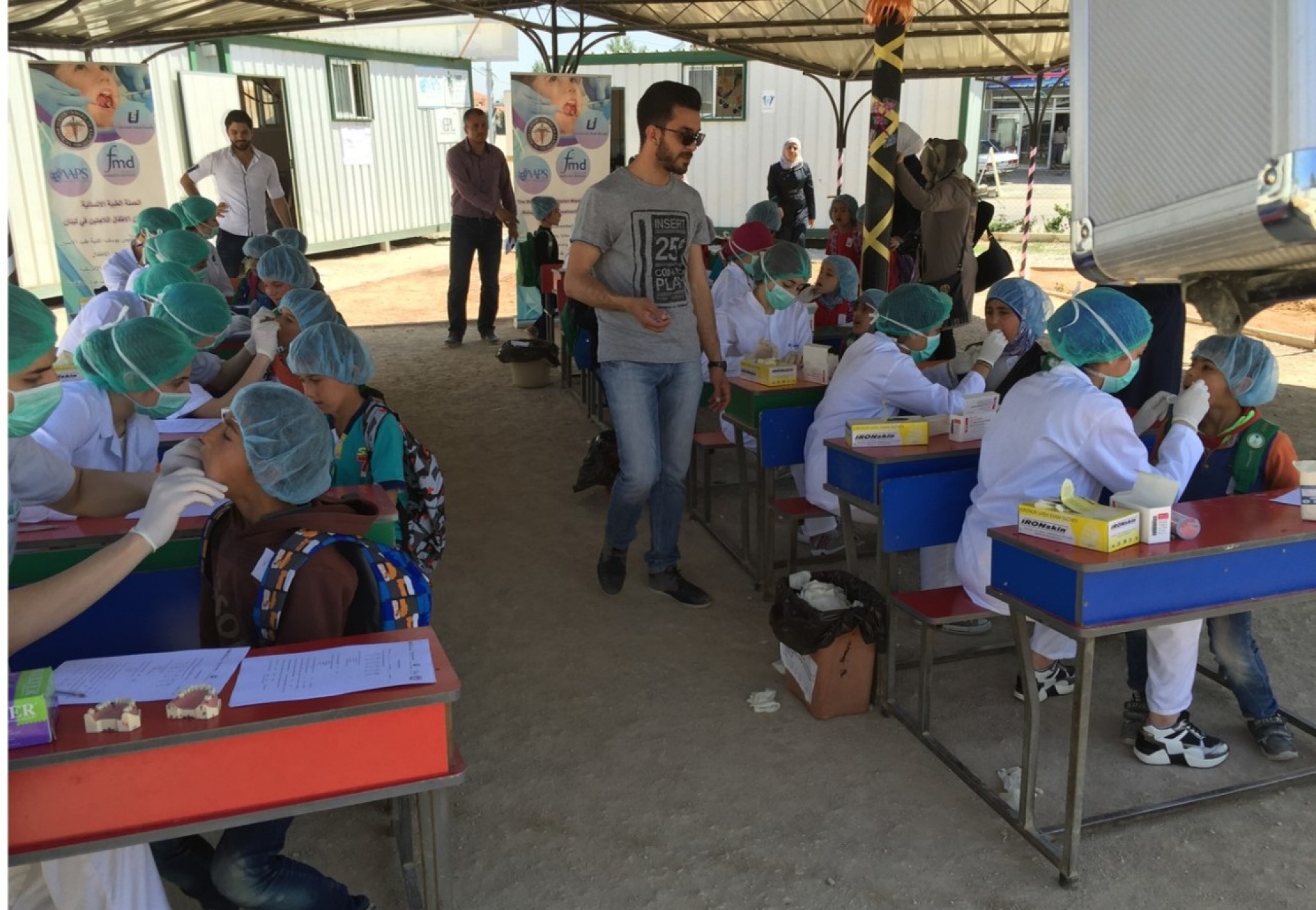 Dentists treating students.