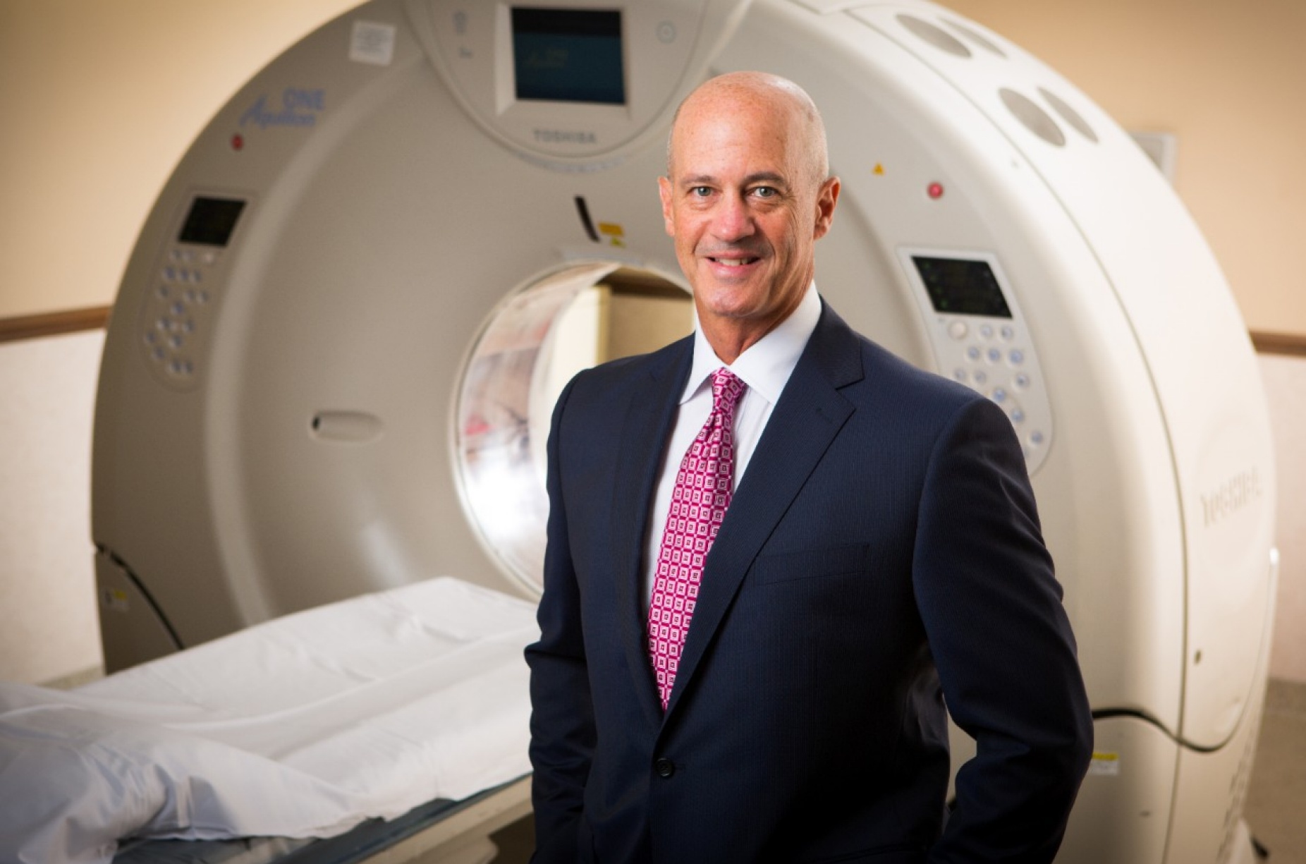 Kenneth Pearsen, MD, MRI machine in the background. 