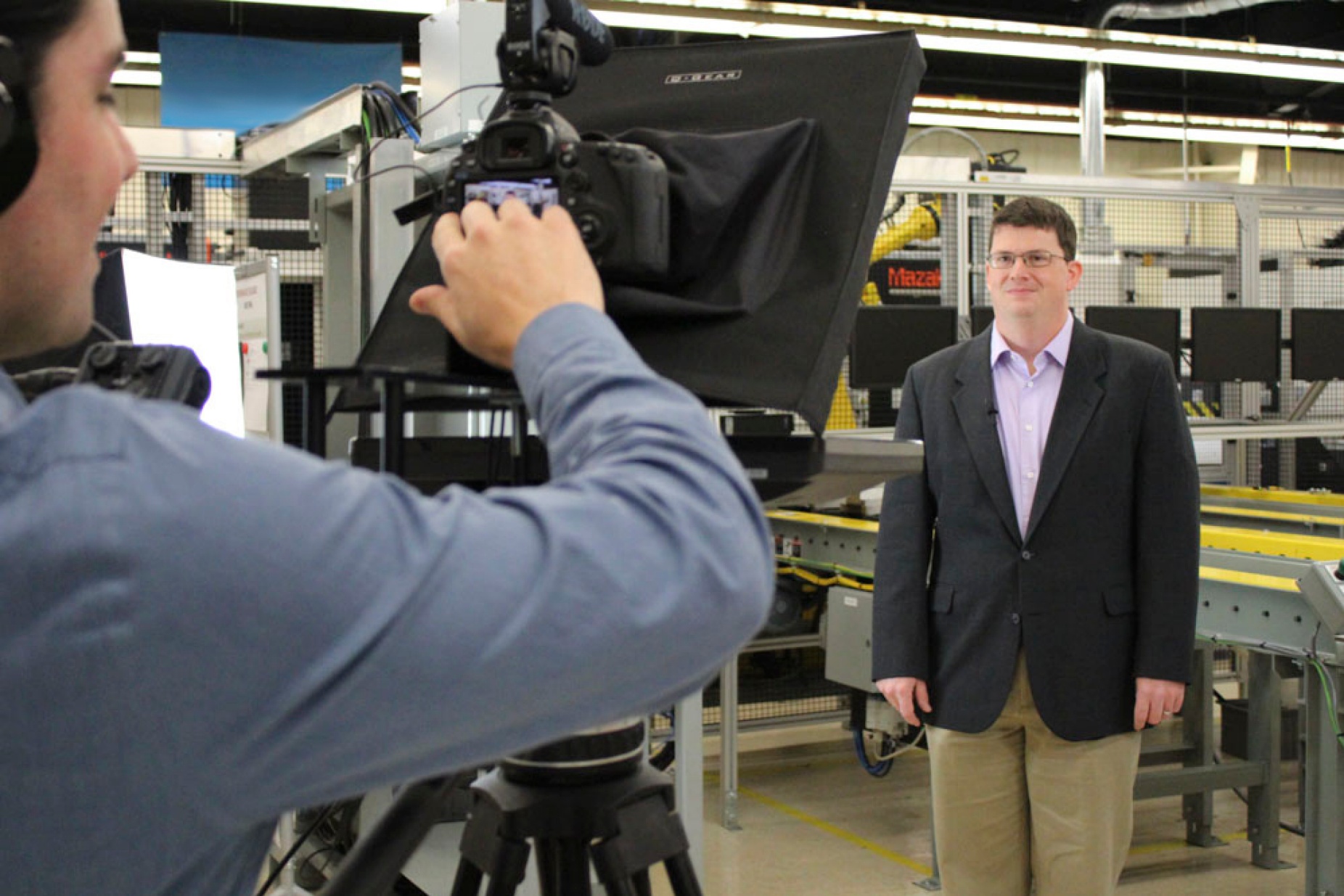 Kenneth English, PhD, deputy director of SMART at UB, films an introduction to one of the digital manufacturing and design courses at Moog, Inc. Behind the camera is J. Michael Vick, digital media producer at Full Circle Studios. Credit: Tracy Puckett. 