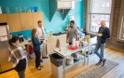 Five colleagues standing in a brightly lit kitchen. 