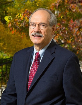 Joseph J. Zambon outdoor portrait in front of trees. 
