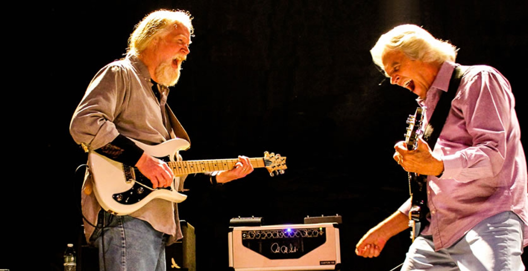 John McLaughlin and Jimmy Herring performing on stage.