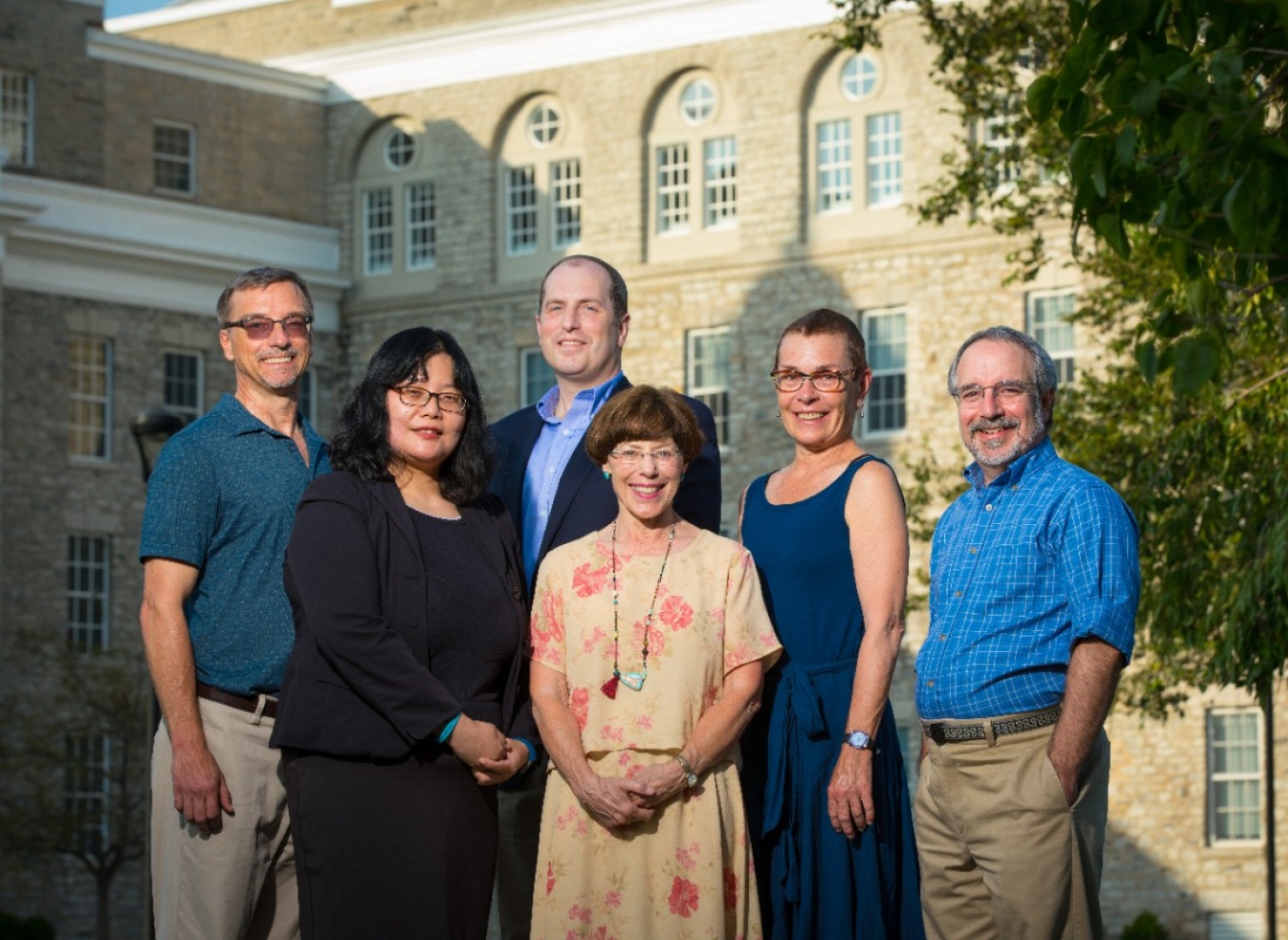 Portrait of grant investigators in front of Hayes Hall on UB South Campus. 