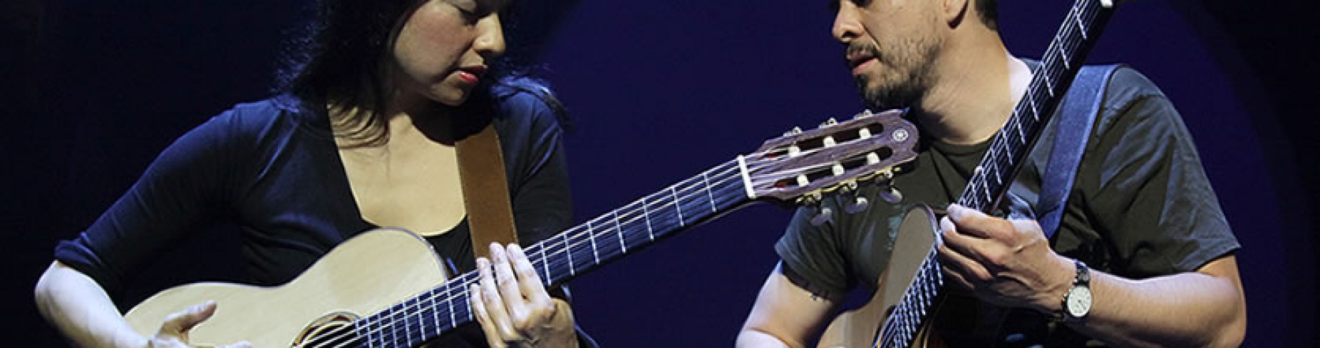 Rodrigo y Gabriela performing on stage.
