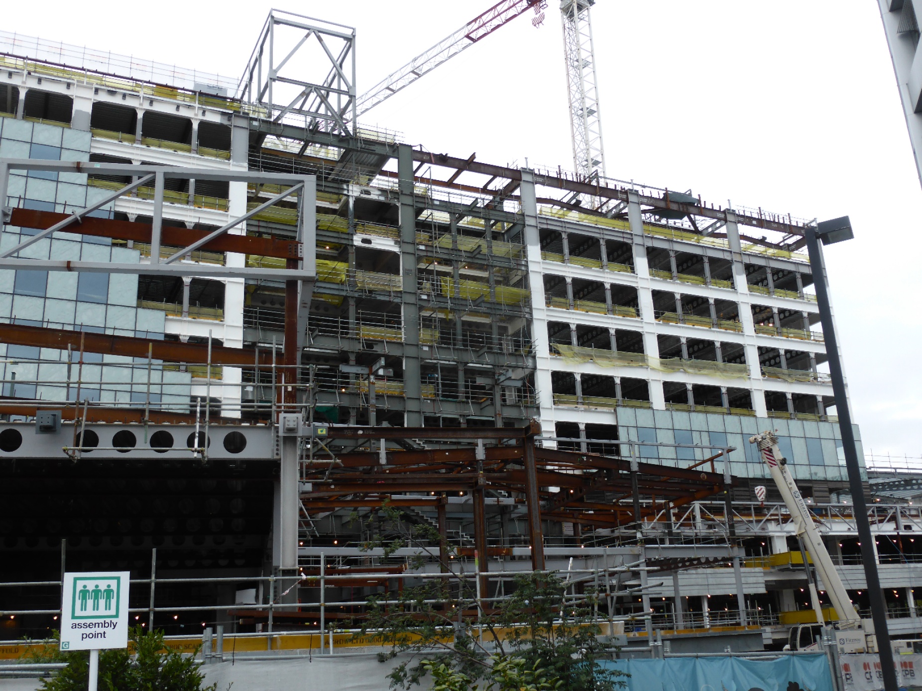 The image shows shows a large hospital being constructed with a ductile moment resisting steel frame (on top of base isolators, but the base isolation system is not shown in the photo). 